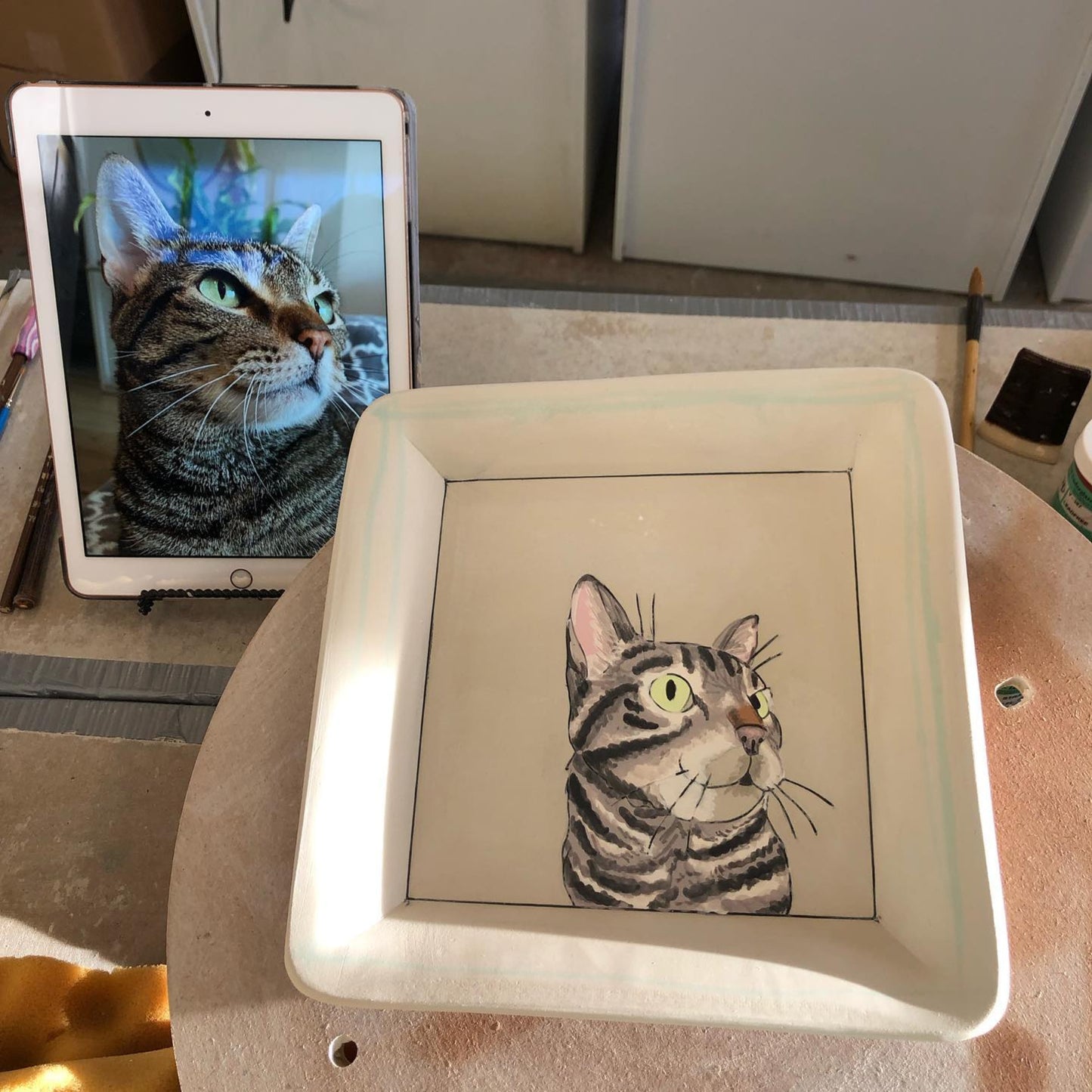 Custom pet portrait square tray. Work-in-progress, greenware stage. With a tabby cat.