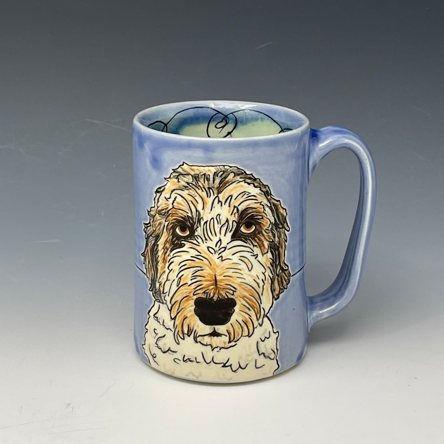 Handmade mug with a custom drawing of a doodle in Blue Glaze