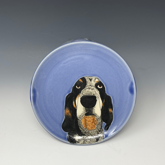 Ceramic bowl with a dog illustration on a blue background