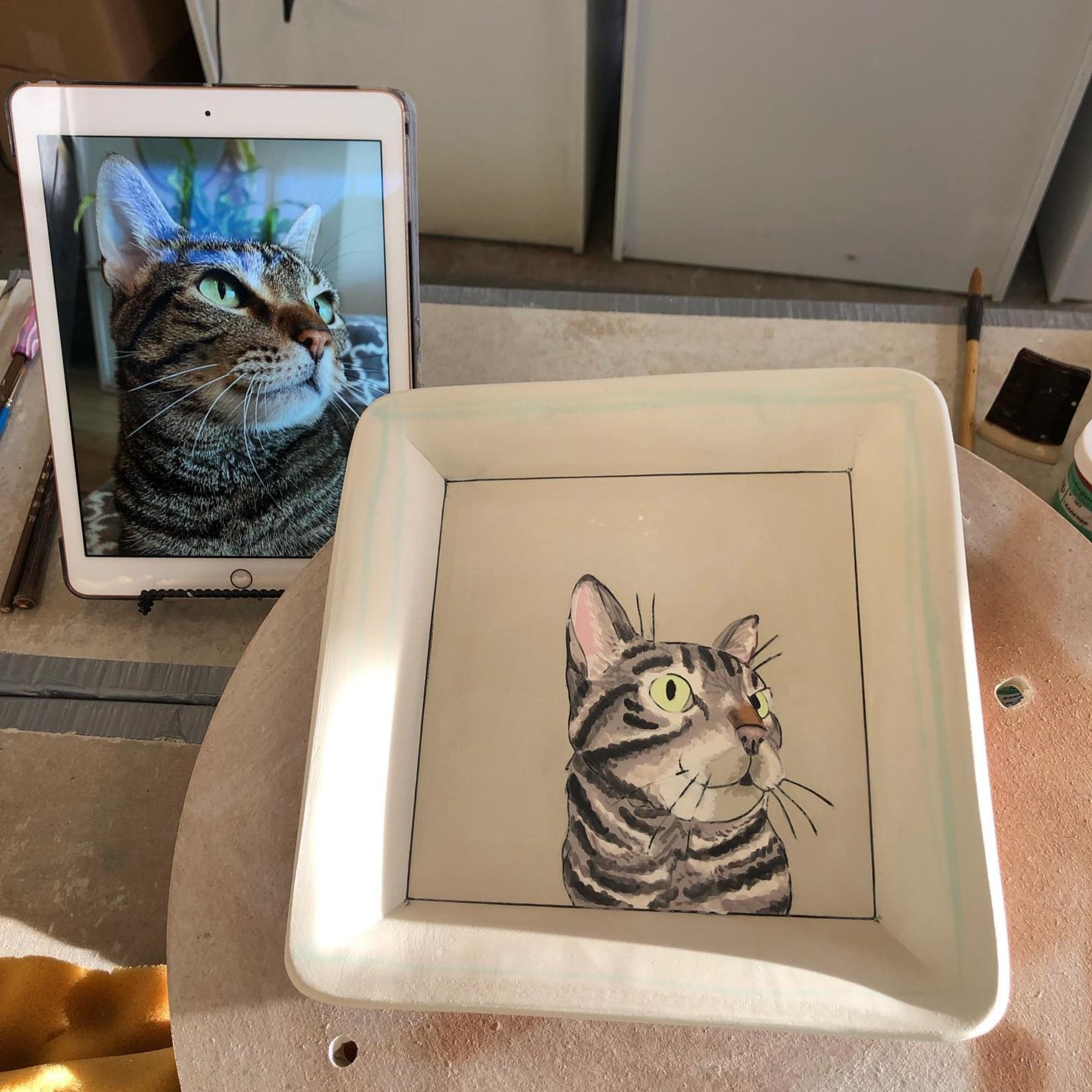 Custom pet portrait square tray. Work-in-progress, greenware stage. With a tabby cat.