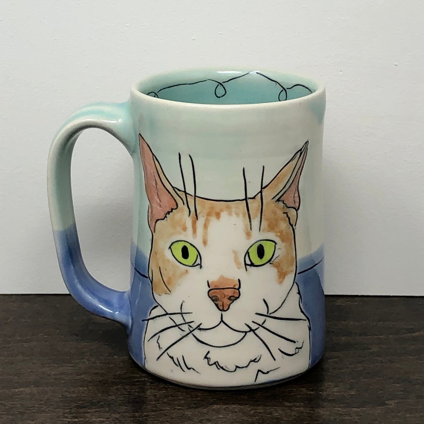Handmade custom mug with a cat in Aqua and Blue glaze