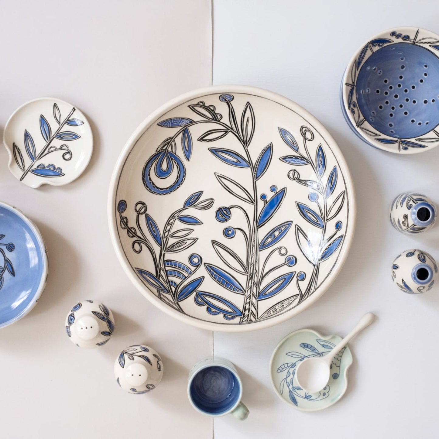 Collection of ceramic dishes with blue and white floral patterns on a light background
