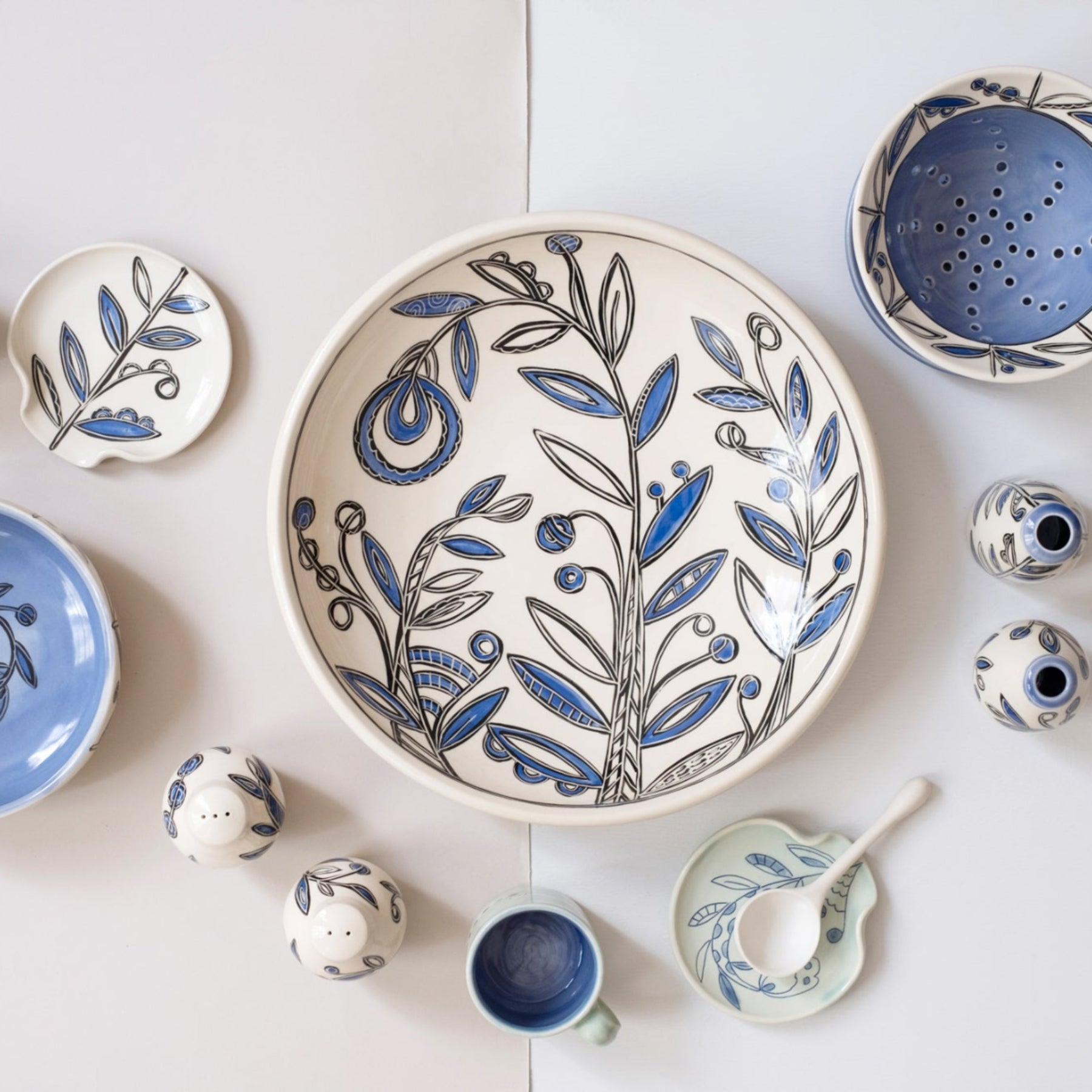 Collection of ceramic dishes with blue and white floral patterns on a light background