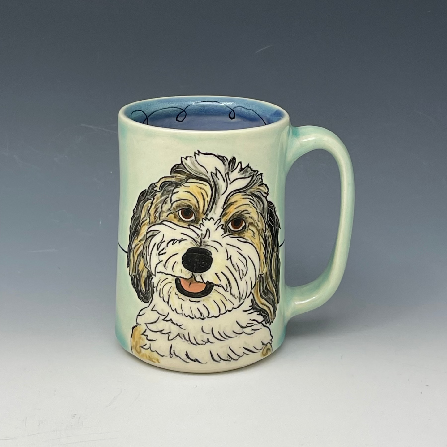 mug with custom drawing of a dog in Aqua glaze