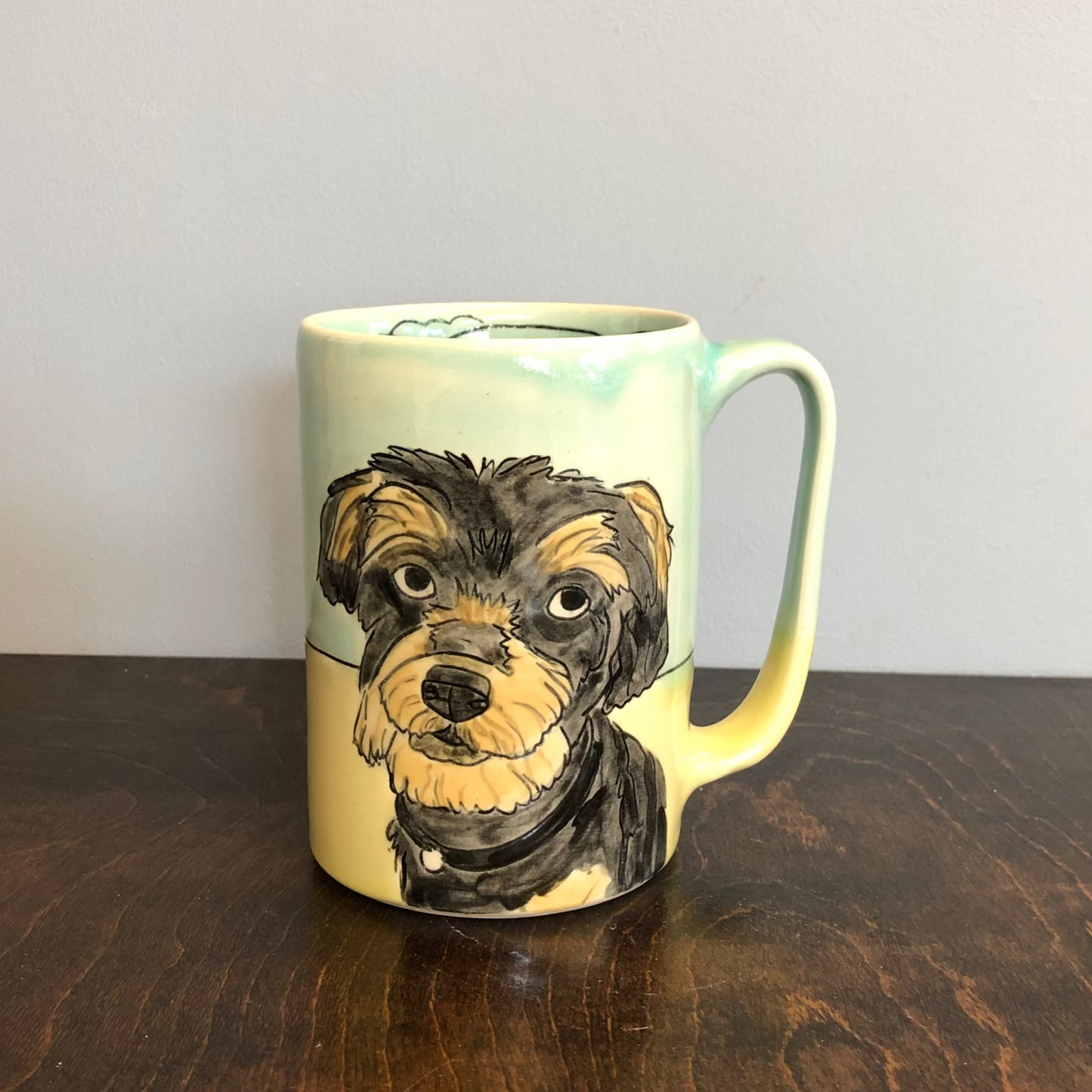 Mug with a dog illustration on a wooden surface